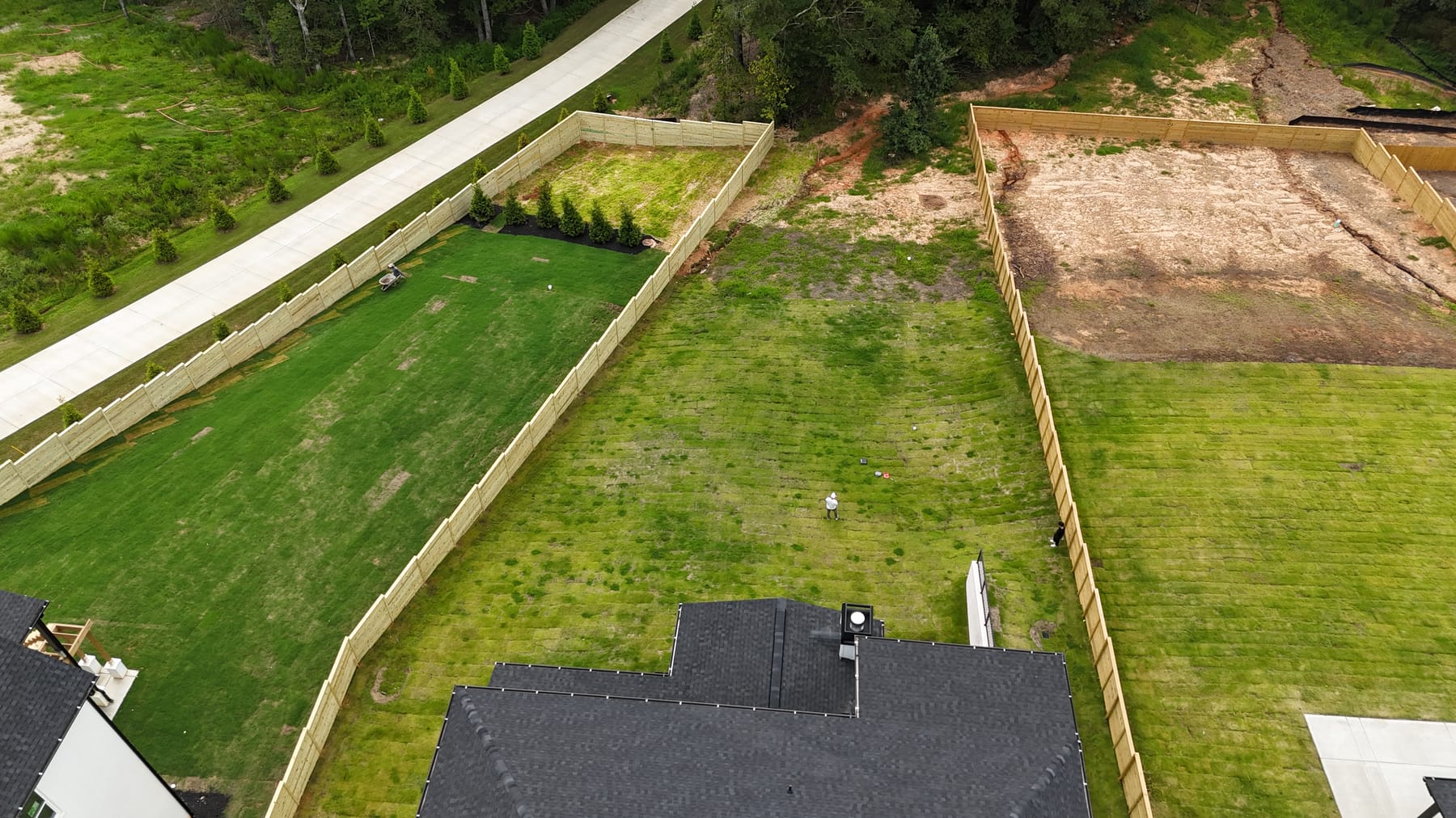 Backyard before sport court installation — empty lawn