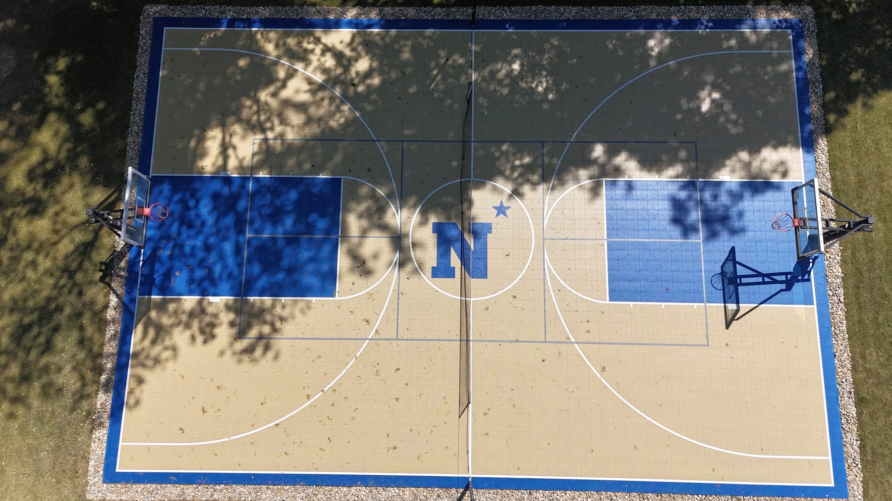 Full basketball court with custom N logo — tan and blue tiles