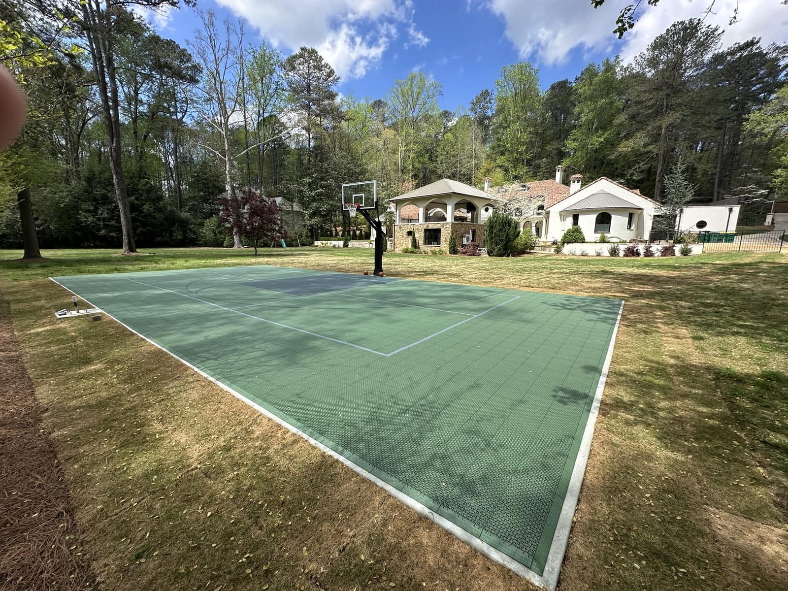 Green multi-sport game court on an estate lawn