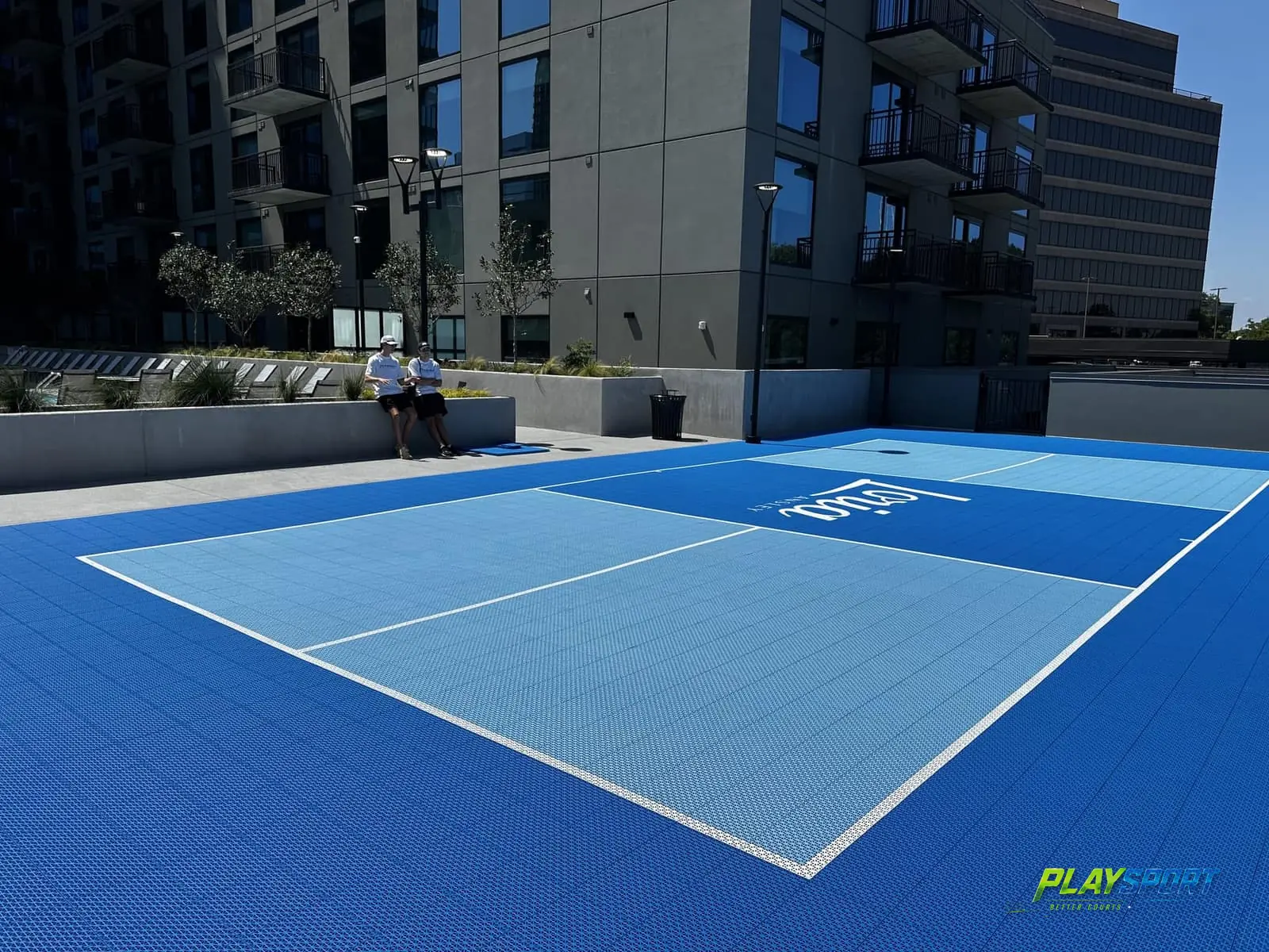 Two-tone blue modular pickleball court on a hotel terrace