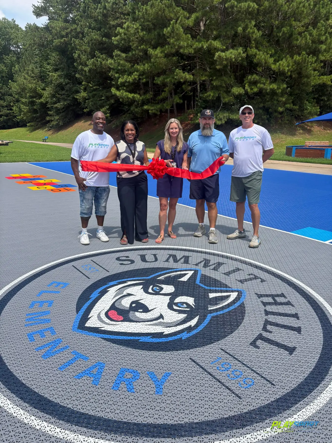 Ribbon-cutting ceremony on the new PlaySport modular basketball court with husky logo at Summit Hill Elementary, Alpharetta GA